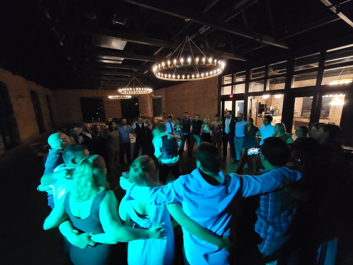 Guests dancing in a circle at a Fargo–Moorhead wedding