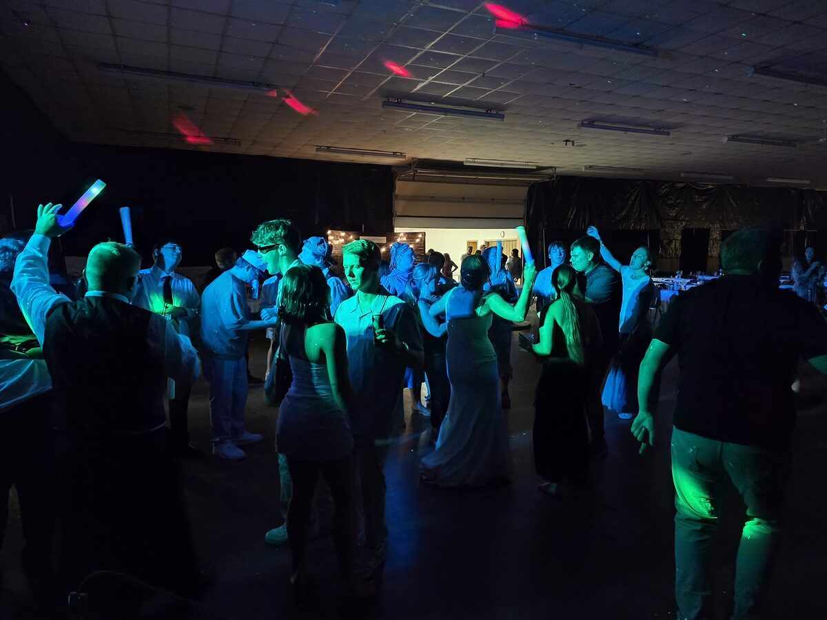 A packed dance floor with glow sticks at a Midnight Express event
